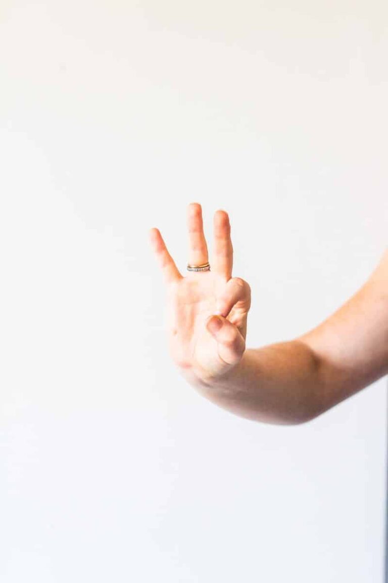 persons hand doing thumbs up